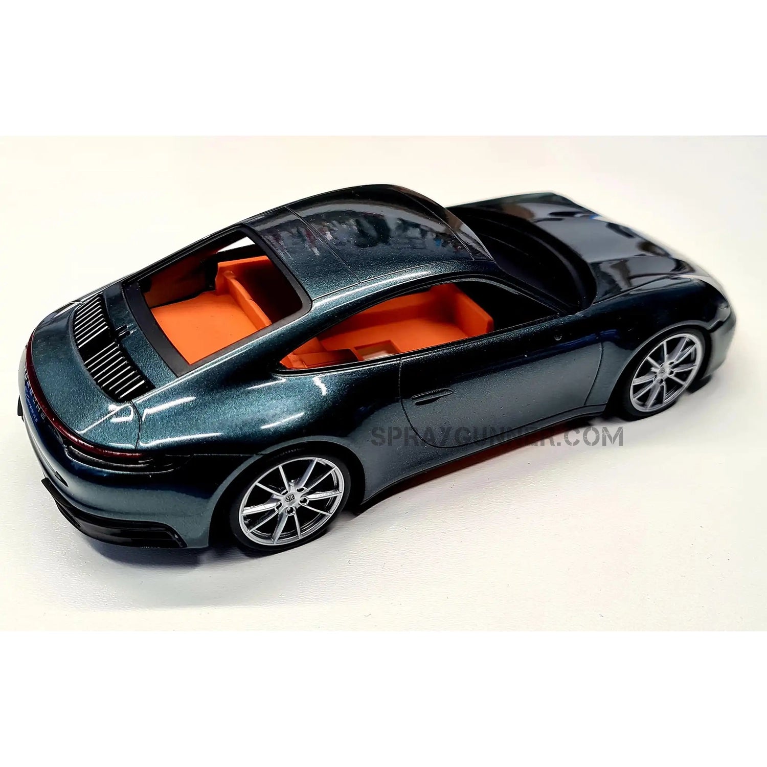 The Porsche 911 Carrera 2021 ALPHA MODEL 1/24 scale model car kit is a meticulously constructed red and gold-rimmed reproduction. ideal for fans of model cars.